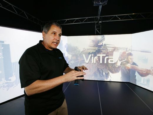 VirTra development manager Scott DiIullo talks about sound, 300-degree views and other features of the V-300 firearms-training simulator, at the company's Tempe headquarters on Nov. 16, 2016. Rob Schumacher/azcentral.com