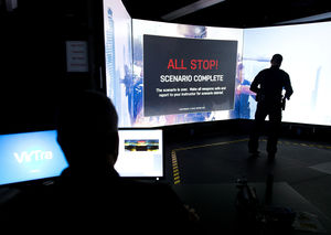 Sgt. Jeff Baker, left, watches after Officer Matt Austin finishes a scenario with the VirTra judgement simulator at the Omaha Public Safety Training Center.